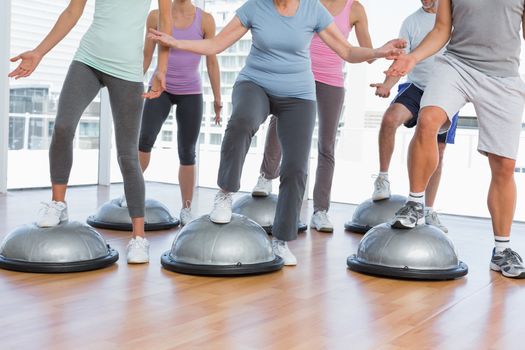 Low section of people doing power fitness exercise at yoga class