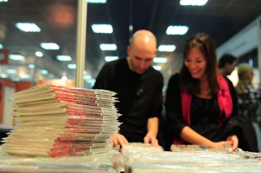 SERBIA, BELGRADE - OCTOBER 27, 2012: People choosing a book at the International Belgrade Book Fair, one of the oldest and most important literary events in the region