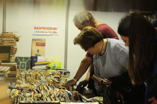 SERBIA, BELGRADE - OCTOBER 27, 2012: People choosing a book at the International Belgrade Book Fair, one of the oldest and most important literary events in the region