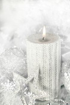 Beautiful shiny silver christmas decor and burning candle