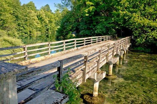 Korana green river old wooden bridge in Slunj, Croatia