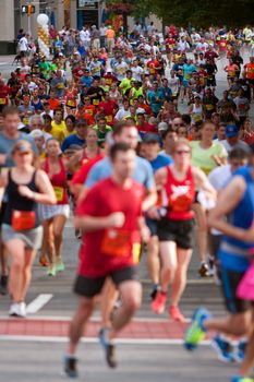 Atlanta, GA, USA - July 4, 2014:  Thousands of runners make their way down Peachtree Street on their way to the finish line of the Peachtree Road Race