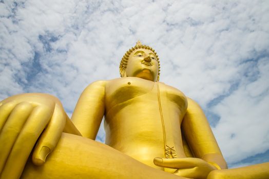 A big Buddha statue in the temple of Thailand.