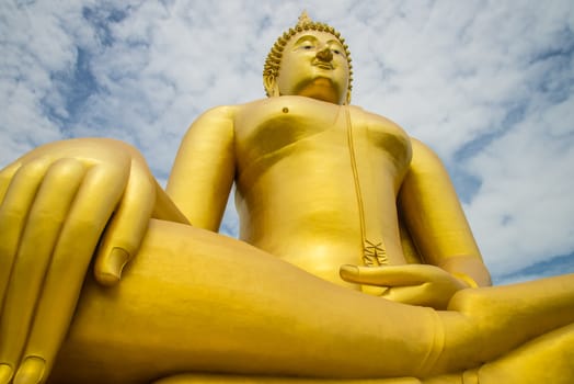 A big Buddha statue in the temple of Thailand.