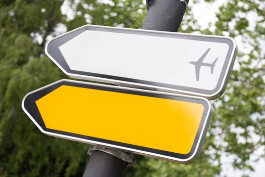 Yellow and white arrow road signs directing to aerport.