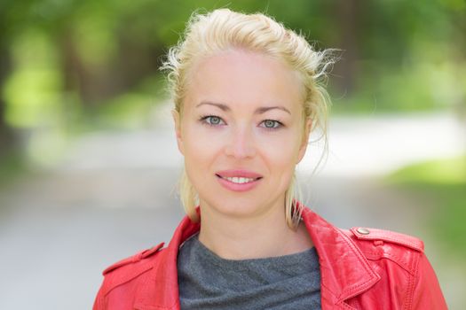 Portrait of happy young woman in the park.