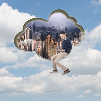 Cloud concept with man sit at a cloud shaped wall and using tablet.