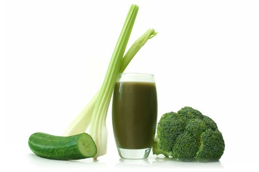 Green smoothie with fresh vegetables over a white background
