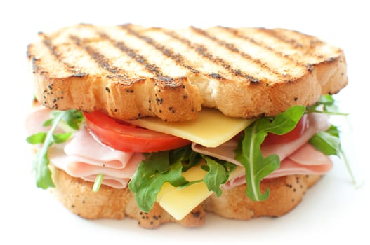 Grilled sandwich with ham and cheese and rocket salad 