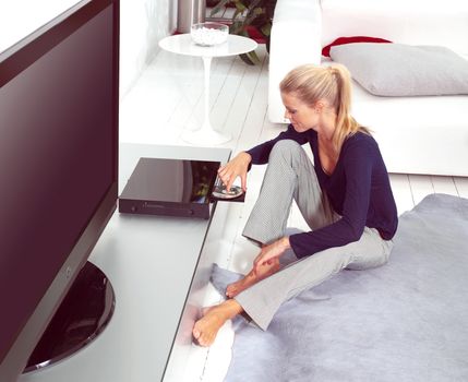 woman using dvd player in her flat