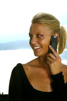 Beautiful woman talking on cell phone while looking at copyspace 