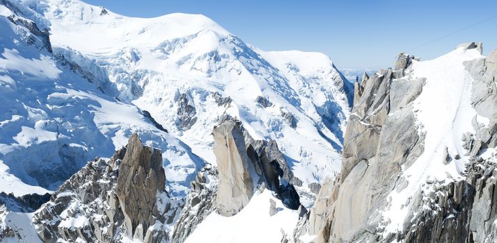 Panoramic composite of Mont Blanc mountain range, In Chamonix, France, with climbers on its rocks