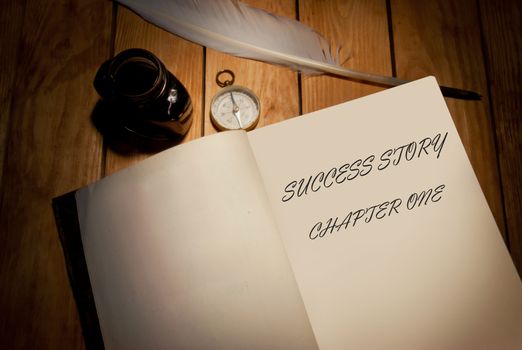 Success story handwritten first page of a book with quill and ink