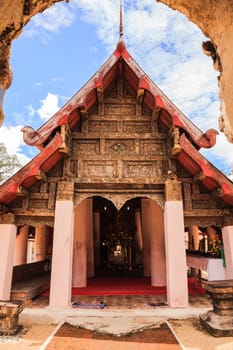 Ancient viharn of lanna style temple with the very beautiful carving decoration on the facade