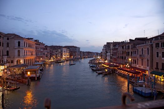 sun sets at the rialto bridge as the market lights up 