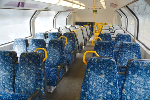 Interior of a passenger train with empty seats