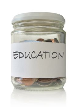 Glass jar filled with coins labeled with education