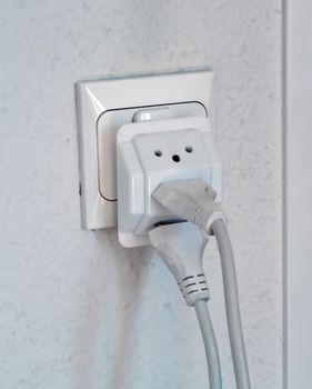 Multiple electrical plugs in wall outlet, Switzerland, Europe