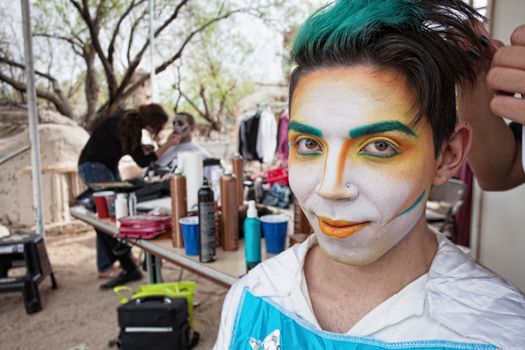 Handsome young Hispanic cirque actor with face makeup