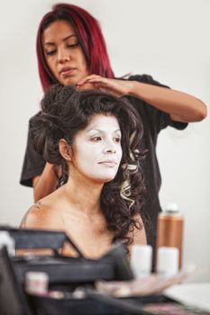 Native American makeup artist working beautiful female performer