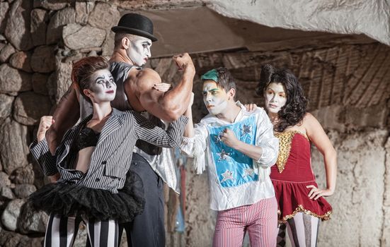 Circus comedy drama ensemble performing at outdoor theatre