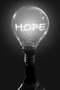 Illuminated hope sign inside a light bulb