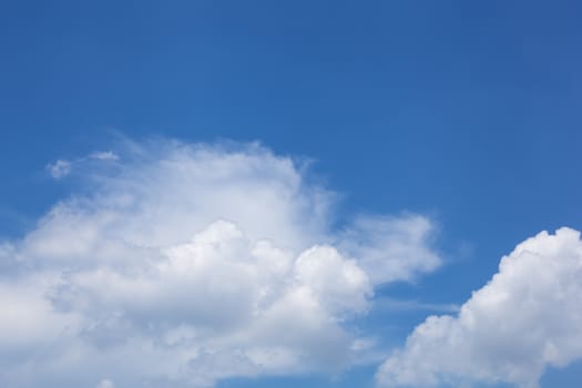 Dynamic white sparse clouds over blue sky. Copy space