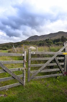 chained gate with mountains in the background