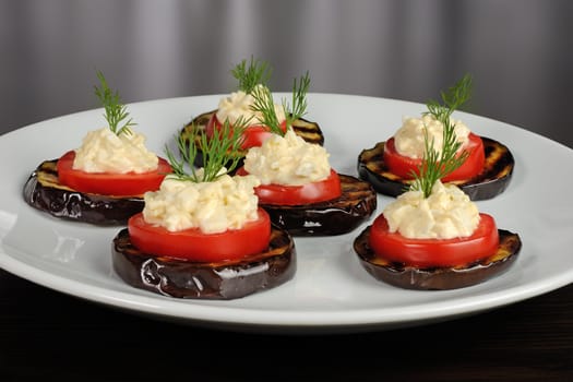 appetizer of grilled eggplant with tomato and spicy stuffing