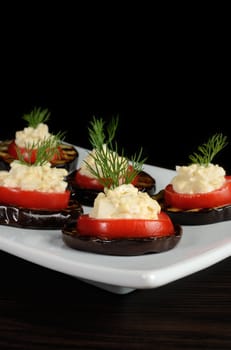 appetizer of grilled eggplant with tomato and spicy stuffing