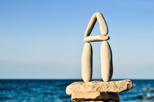 Balancing of white pebbles each other on the seacoast