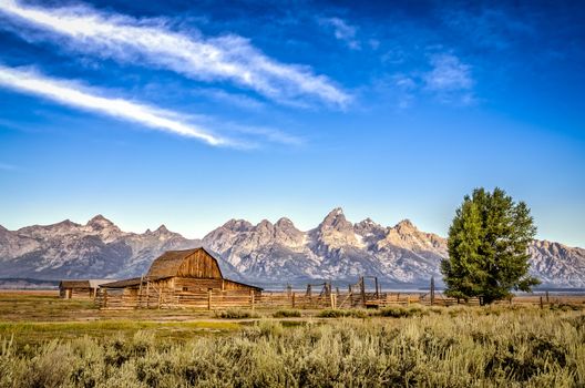 Scenic view of Grand Teton mountain range and abandoned barn, Wyoming, USA