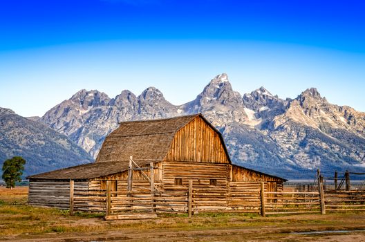 Landscape view of abandoned barn and mountain range, Grand Teton, Wyoming, USA