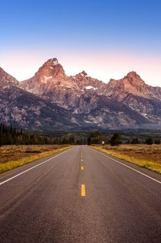 Scenic view of Grand Teton mountain range and road, Wyoming, USA