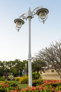 White lamp on pole retro style in garden