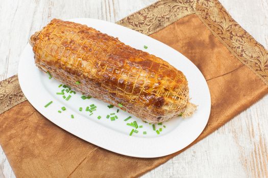 Freshly grilled meat roulade in a white plate. ready to eat. Copy space composition