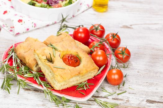 Focaccia italian bread slices with tomato and rosemary