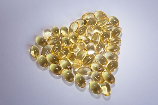 Cod liver oil Omega 3 gel capsules in the form of heart isolated on white background 