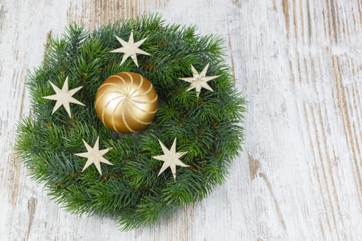 Christmas wreath with bauble on the old wooden background. Copy space composition