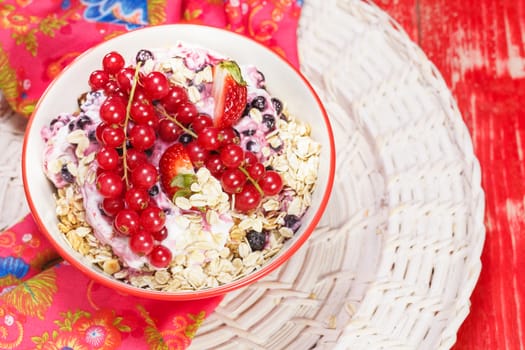 Delicious and healthy breakfast with oatmeal, currant, strawberry and lots of dry fruits, nuts and grains