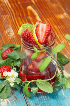Glass mug with infuser and fresh berry fruit with lime