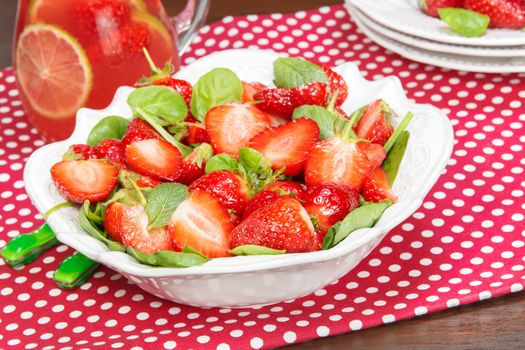 Strawberry Spinach Salad and fruit juice on dining table