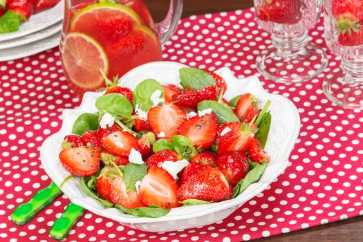 Strawberry Spinach Salad and fruit juice with glasses on dining table