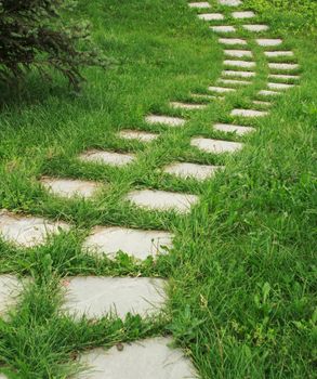 stone walkway on the grass in the park