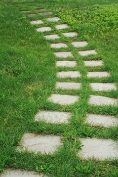 stone walkway on the grass in the park