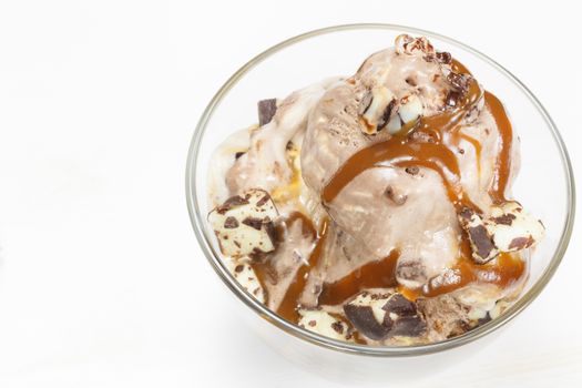 Sundae topped with caramel syrup and chocolate truffle.