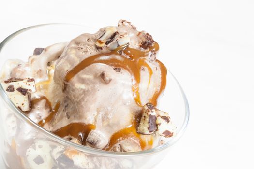 Ice Cream Sundae topped with caramel syrup and chocolate truffle. Close up.