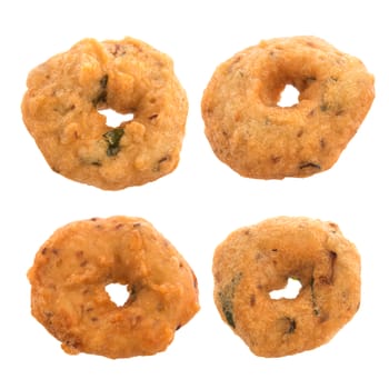 Vada is a savoury snack from South India, very common street food in the Indian Subcontinent and Sri Lanka, shoot isolated on white background.