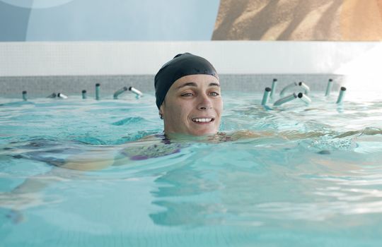 picture of a young happy woman who swimming 