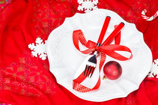 Christmas table setting in festive red white colours. Copy space composition.
